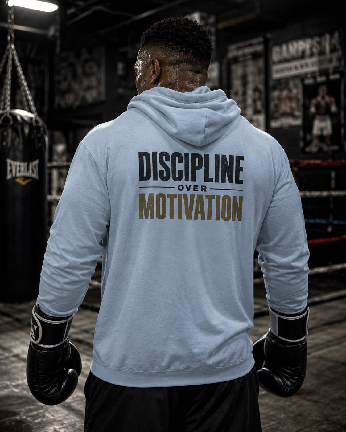 Boxer in a gym wearing the Discipline Over Motivation hoodie