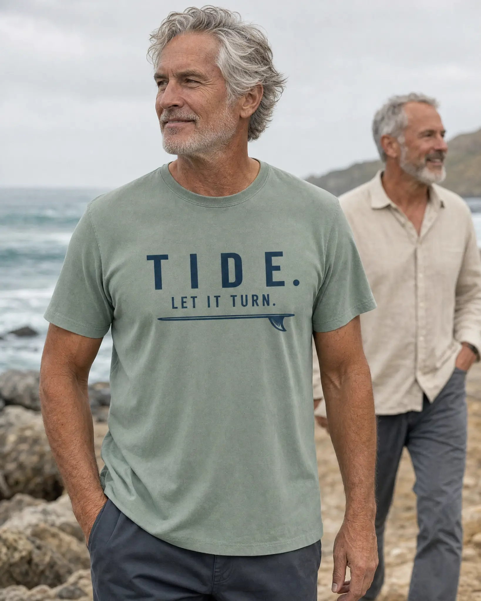 Two men walking beside the ocean in Tide graphic shirts